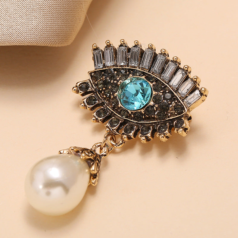 Pearl and diamond-encrusted alloy evil eye brooch