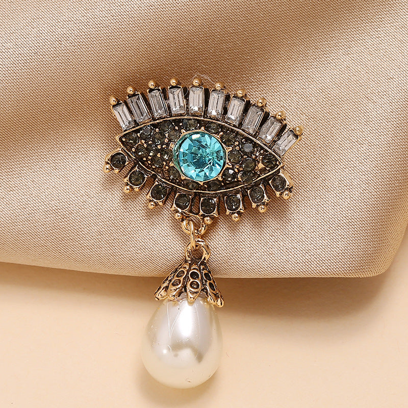 Pearl and diamond-encrusted alloy evil eye brooch