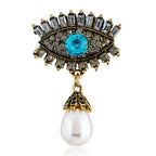 Pearl and diamond-encrusted alloy evil eye brooch