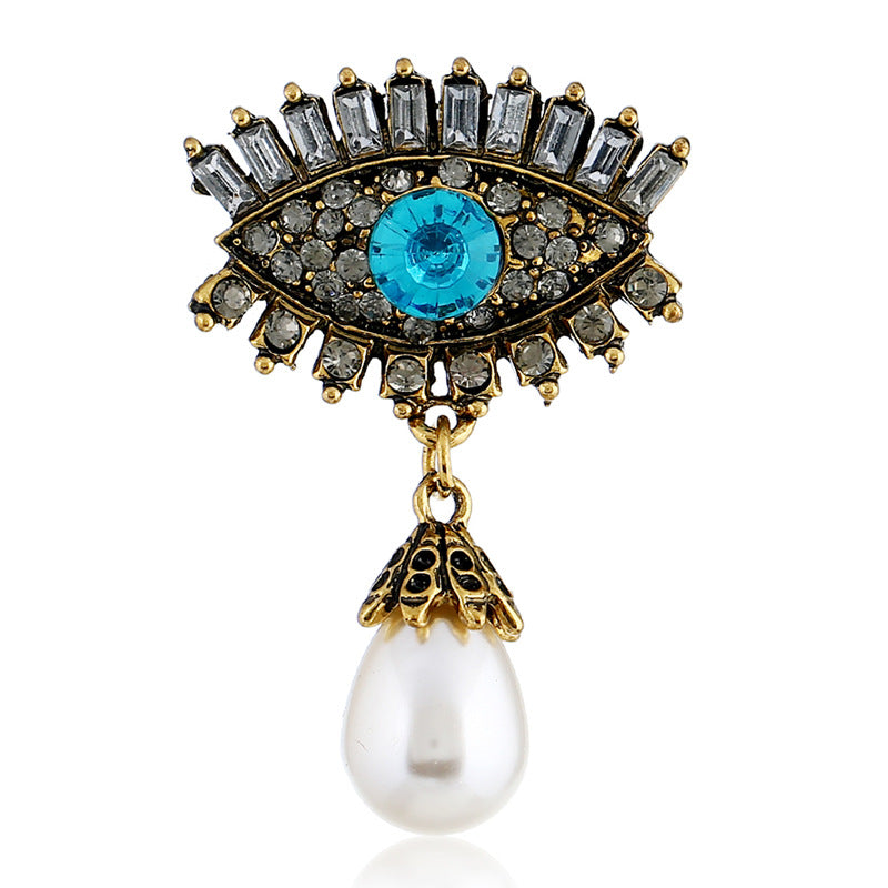 Pearl and diamond-encrusted alloy evil eye brooch