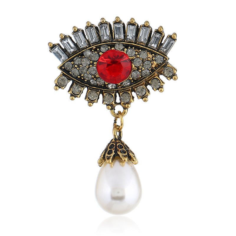 Pearl and diamond-encrusted alloy evil eye brooch