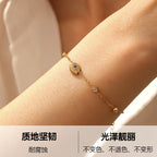 Diamond-encrusted gold-plated stainless steel evil eye bracelet link